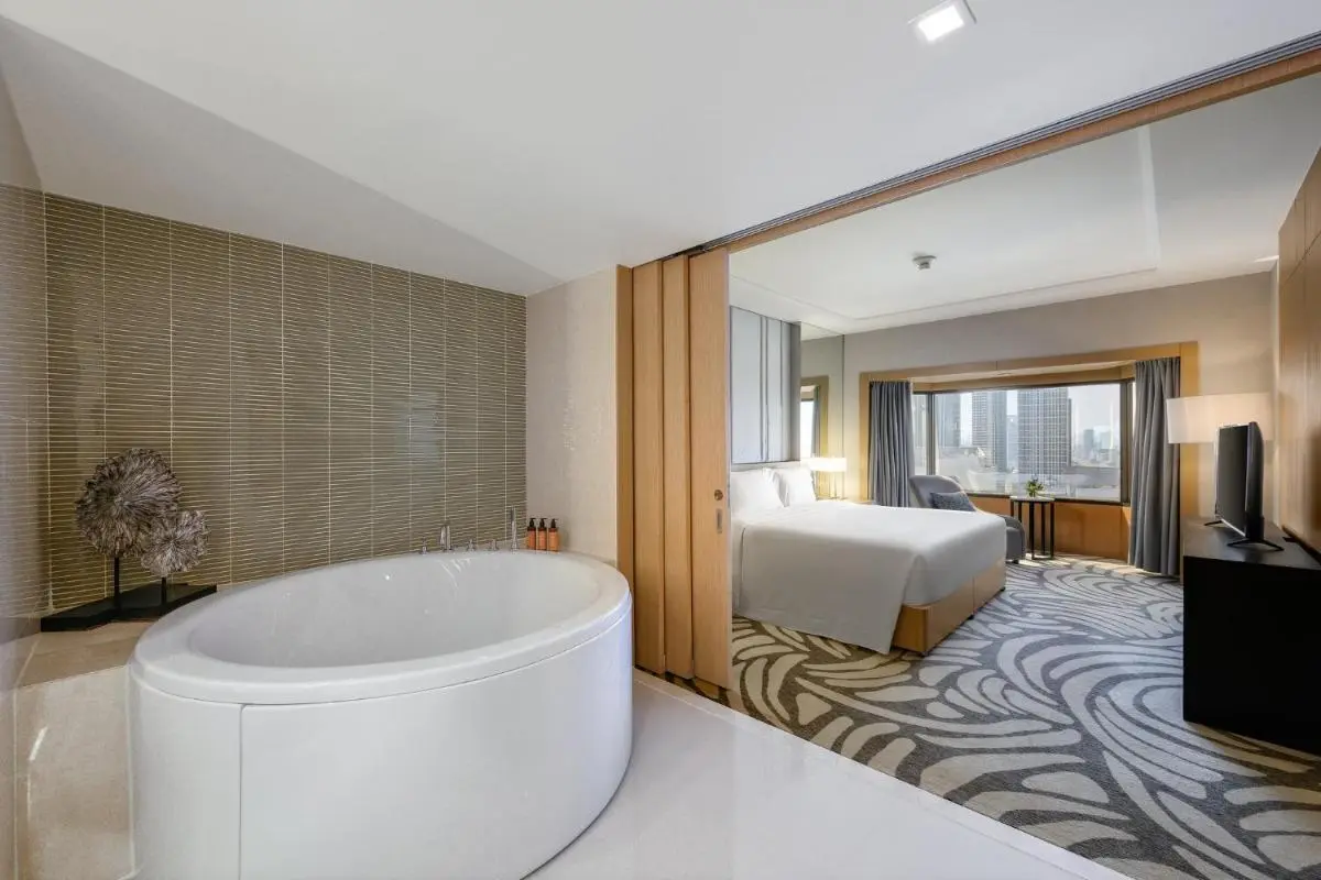 Modern Hotel Suite in Chatuchak Featuring Oval Freestanding Bathtub and City Views