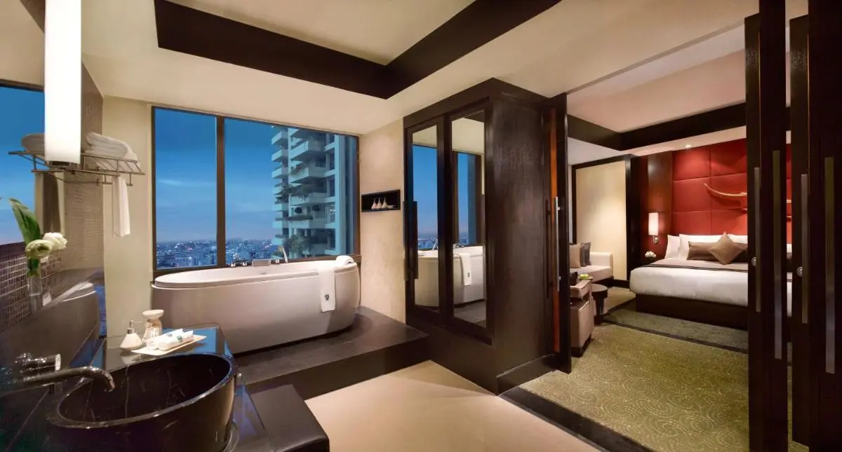 Modern Hotel Suite in Sathorn Featuring Freestanding Bathtub with City Views