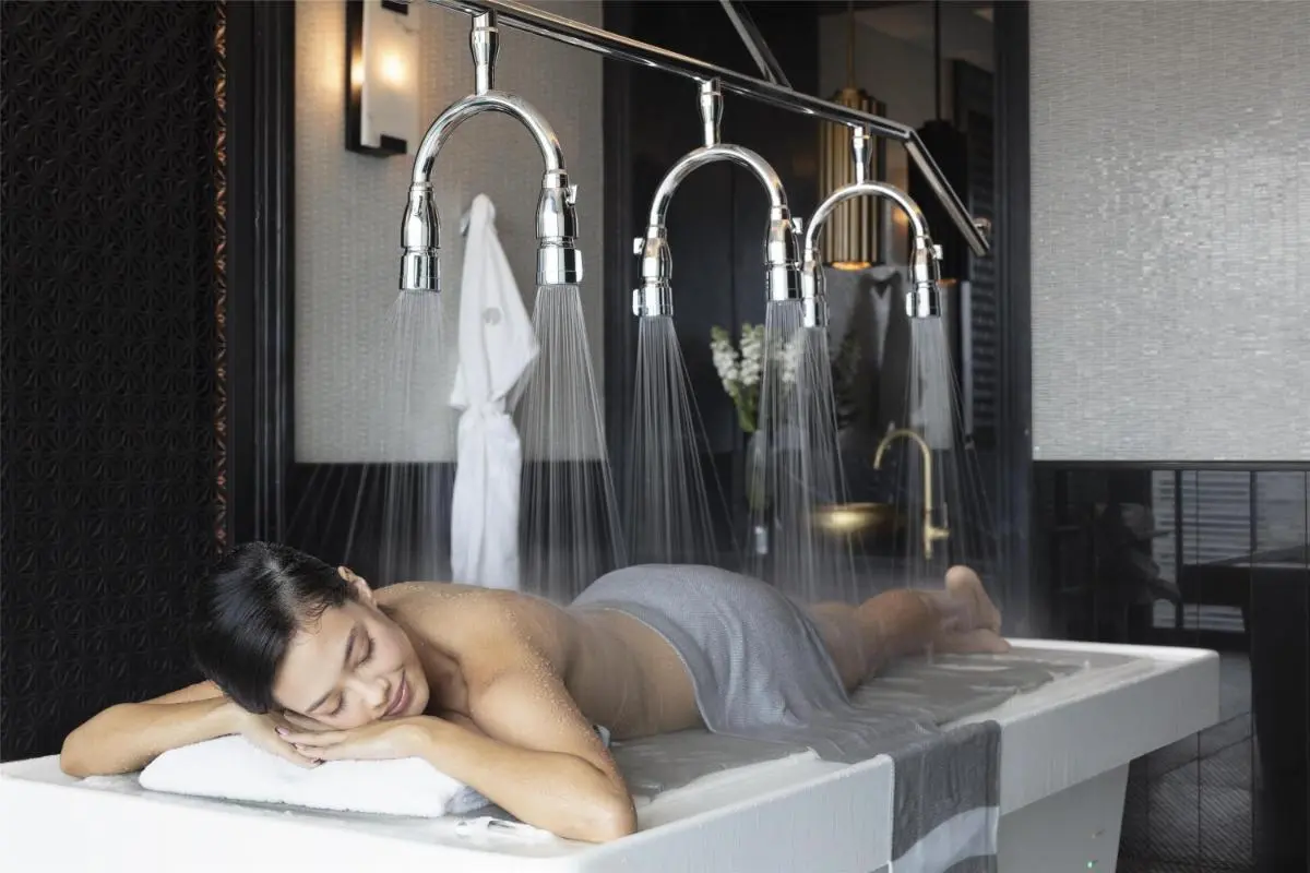 Modern Hydrotherapy Massage Room with Water Basin and Shower Heads in Pathumwan Wellness Facility
