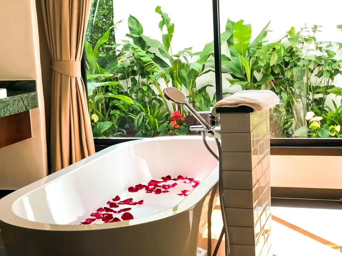 Modern Indoor Bathroom with Freestanding Tub and Garden View in Chiang Mai