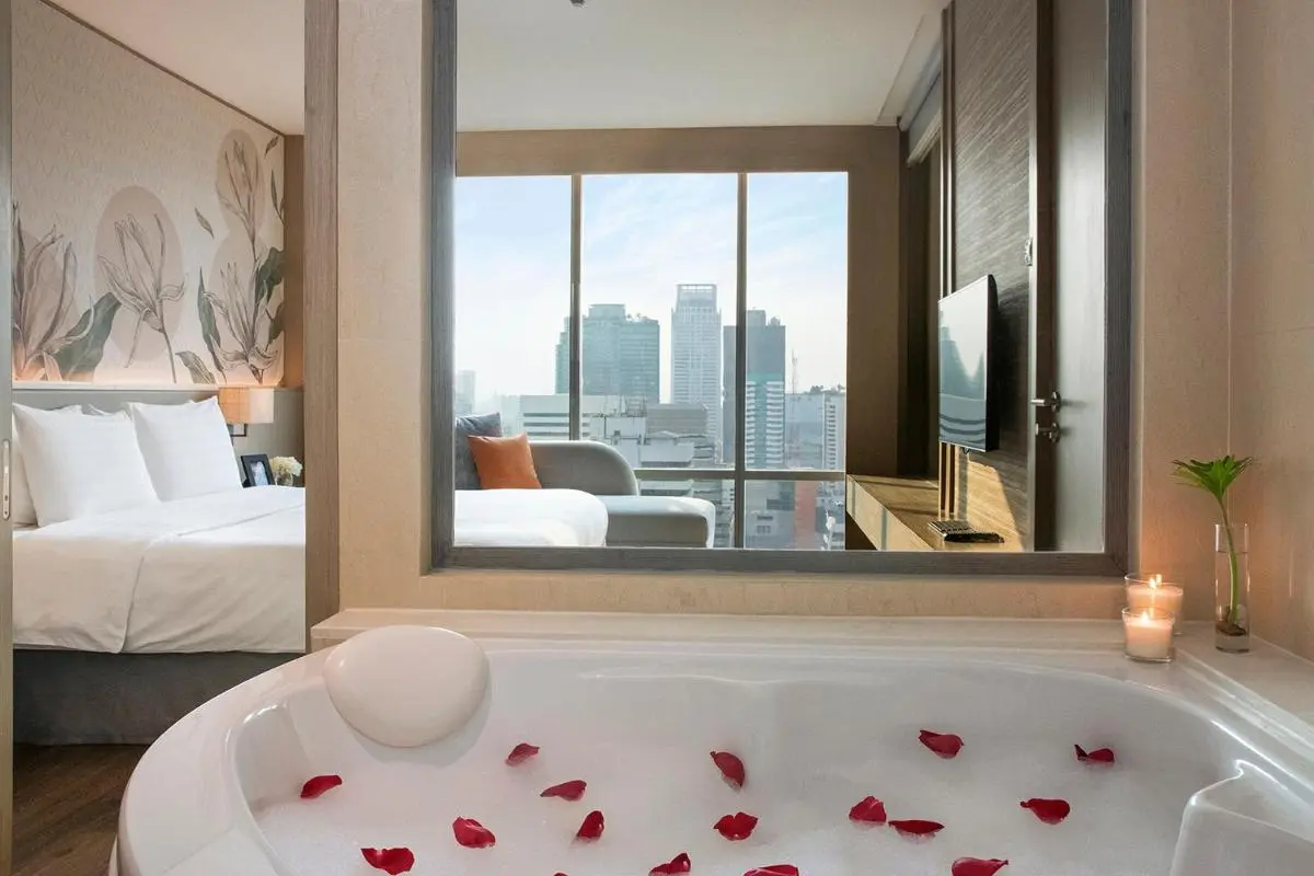 Modern Indoor Bathroom with Oval Bathtub and City View in Pathumwan Bangkok