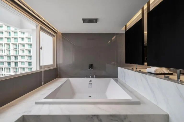 Modern Indoor Bathtub and Shower Area with Marble Surround in Khlong Toei Urban Bathroom Modern Indoor Bathtub and Shower Area with Marble Surround in Khlong Toei Urban Bathroom