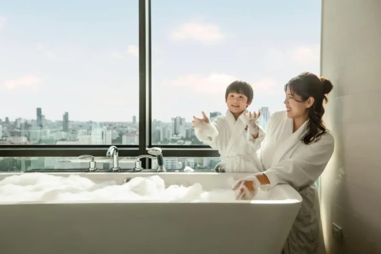 Modern Indoor Bathtub with City View and Foam Bubbles in Pathumwan Bangkok