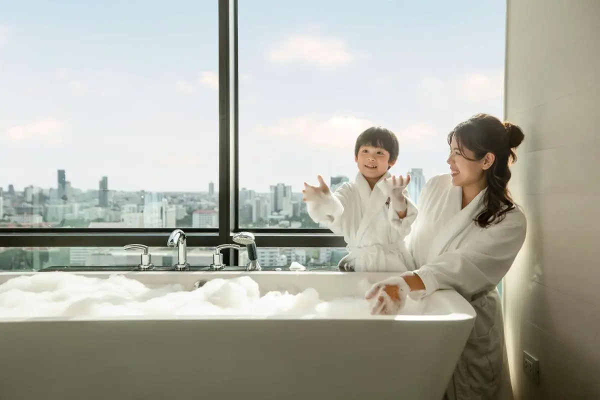 Modern Indoor Bathtub with City View and Foam Bubbles in Pathumwan Bangkok
