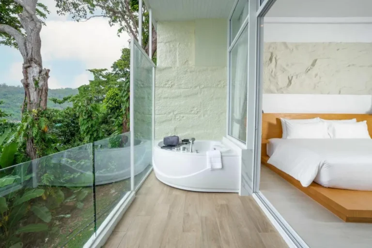 Modern Indoor Bathtub with Forest Views and Adjacent Bedroom at Karon Beach