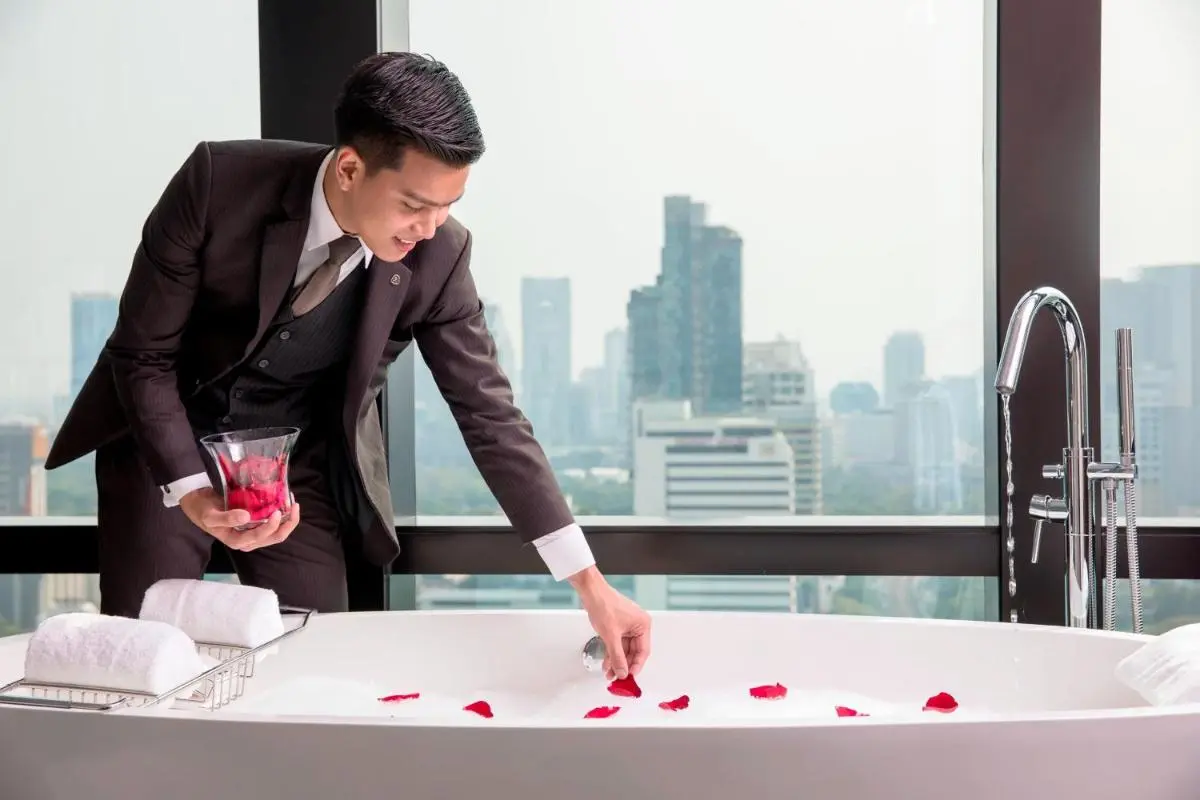 The St. Regis Bangkok Modern Indoor Bathtub with Rose Petals and Urban Skyline View in Pathumwan