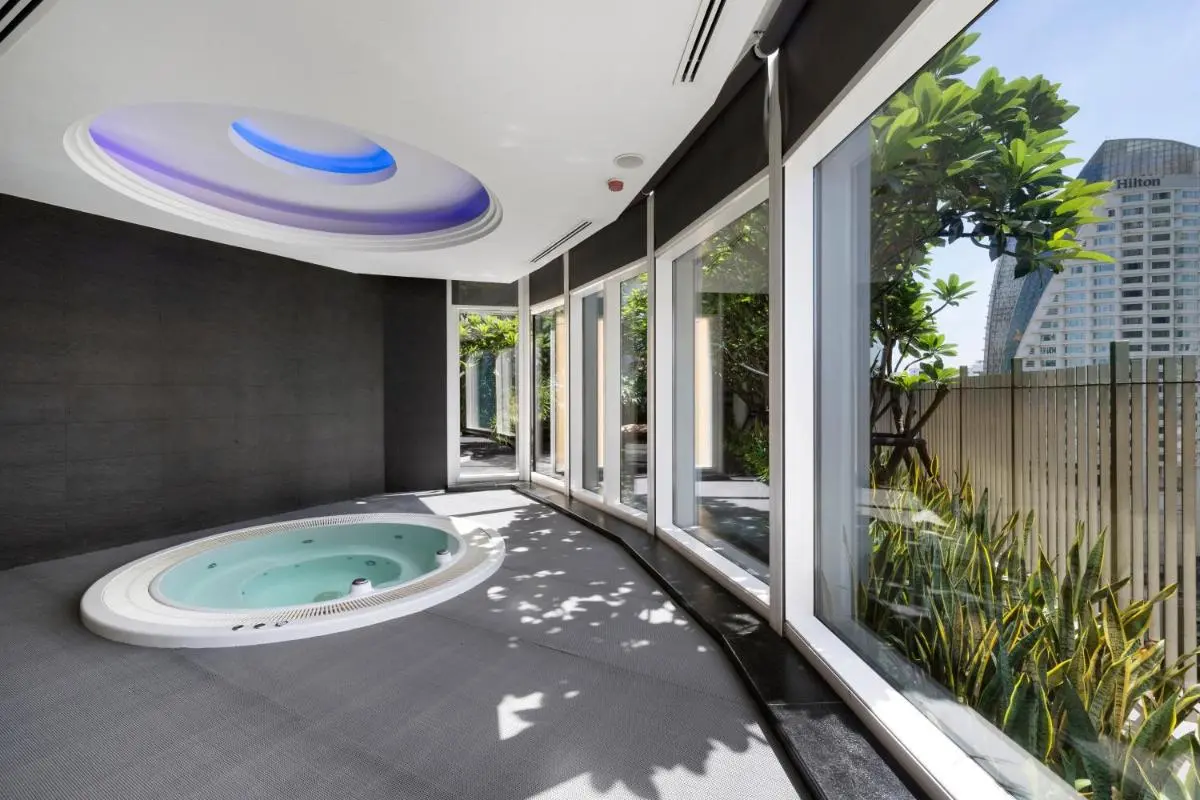 Modern Indoor Jacuzzi and Wellness Area with Natural Light in Wattana Bangkok