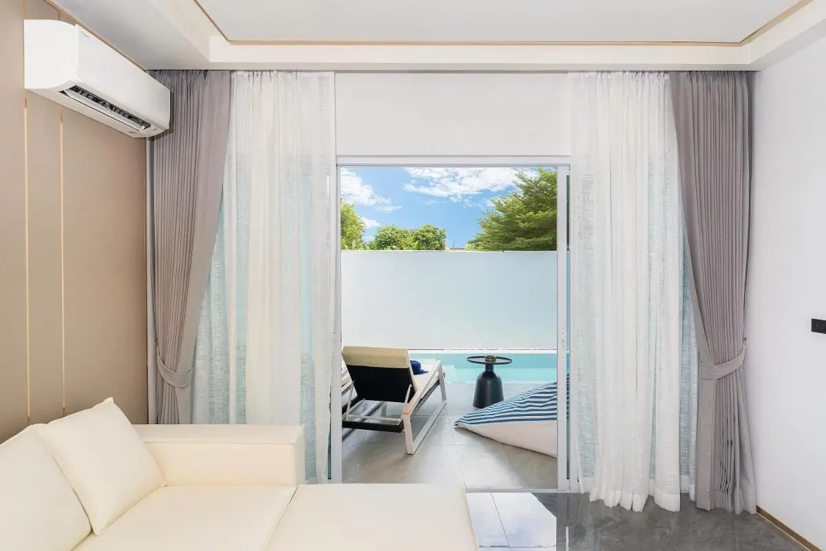 Modern Indoor Lounge with Sliding Door Opening to Private Pool Area in Rawai Beach