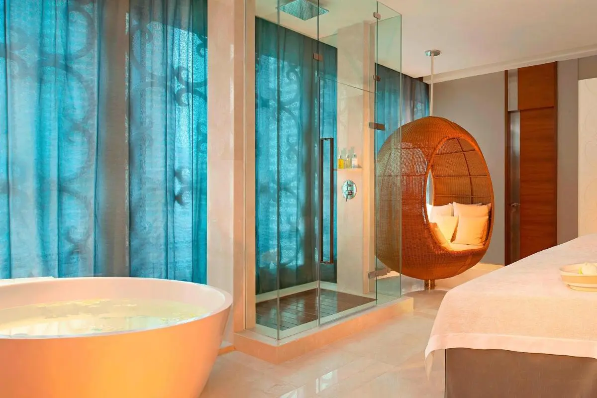 Modern Indoor Spa Room with Bathtub, Shower, and Massage Table in Pathumwan
