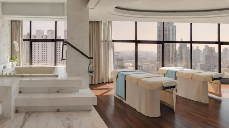 Modern Indoor Spa Room with Massage Tables and Soaking Tub Overlooking Pathumwan Skyline