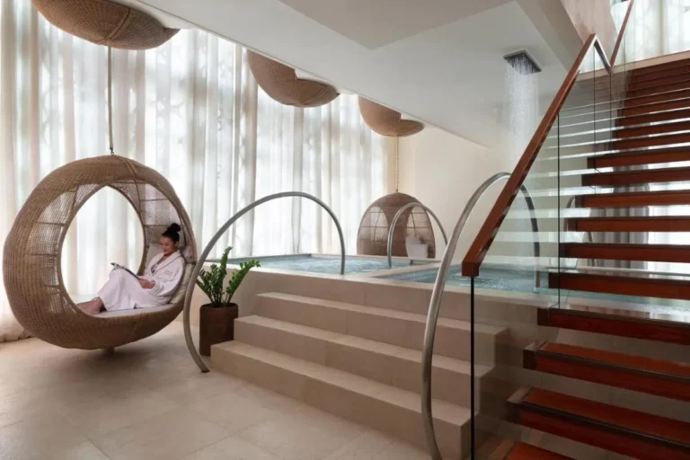 Modern Indoor Wellness Area with Hydrotherapy Pools and Hanging Chairs in Pathumwan Bangkok