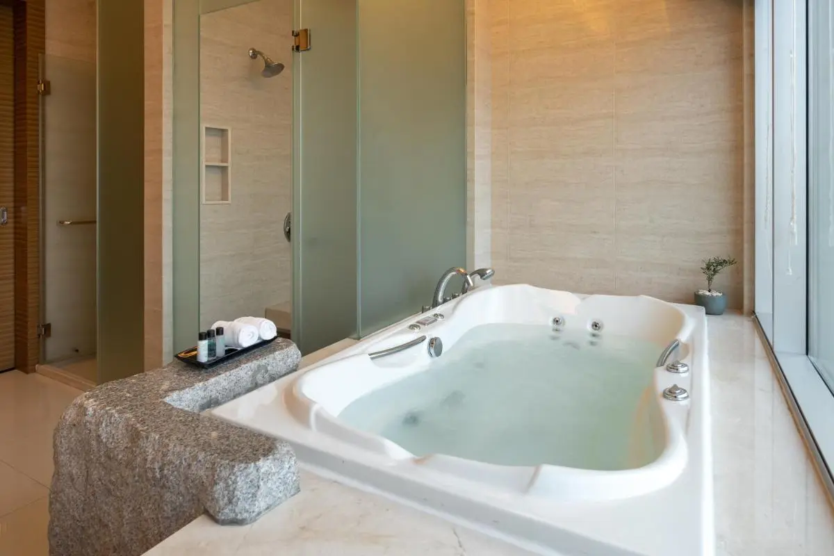 Modern Indoor Whirlpool Bathtub and Shower Area with Natural Light in Wattana Bathroom