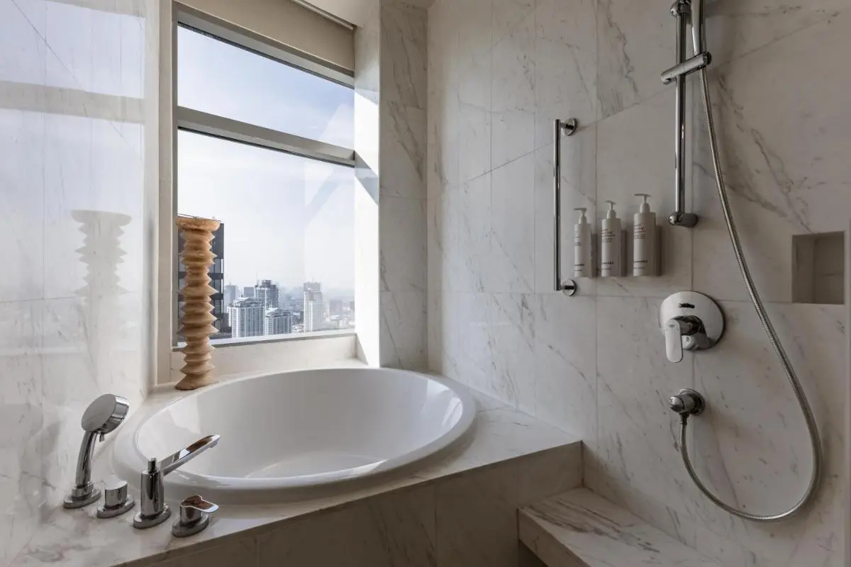 Bangkok Marriott Hotel Sukhumvit Modern Marble Bathroom with Oval Bathtub and City View in Wattana Bangkok