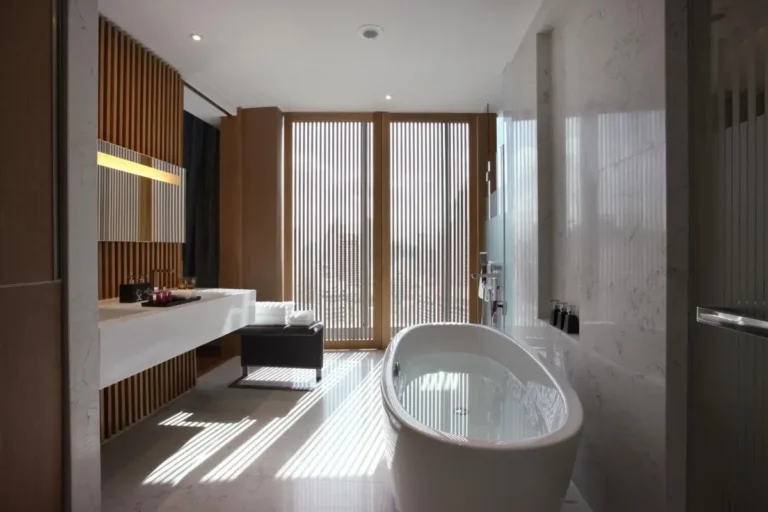 Modern Minimalist Bathroom Design Featuring Freestanding Bathtub and Wooden Accents in Bang Rak