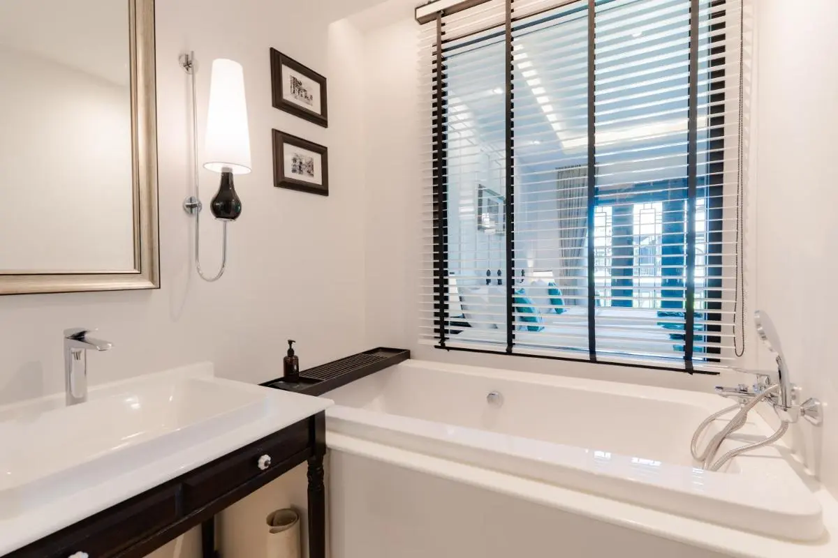 Modern Minimalist Bathroom with Bathtub and Adjacent Seating Area in Phra Sing Chiang Mai