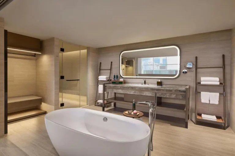 Modern Minimalist Bathroom with Freestanding Bathtub and Glass Shower in Khlong Toei