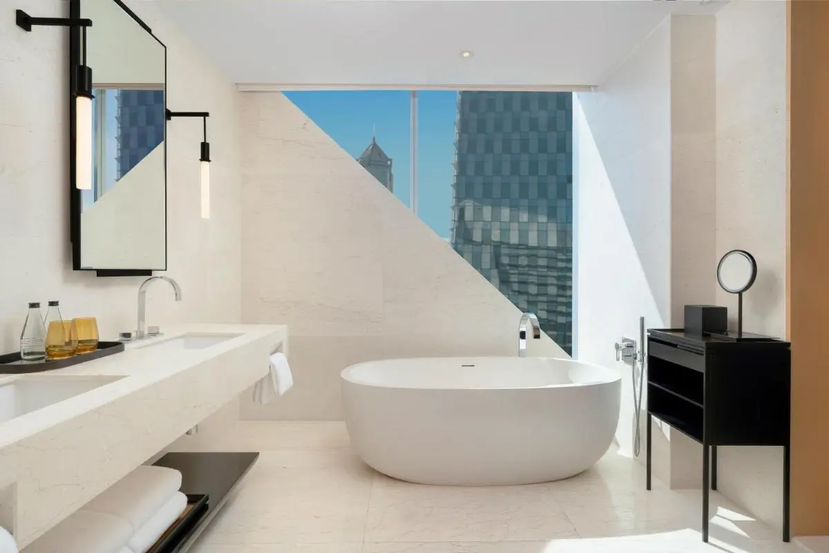 Modern Minimalist Bathroom with Freestanding Bathtub and Urban View in Pathumwan