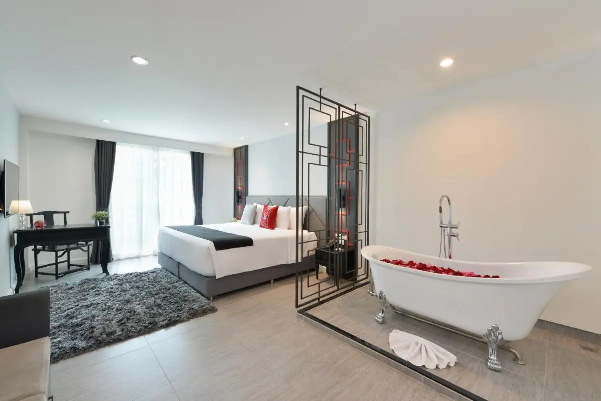 Modern Minimalist Bedroom with Freestanding Bathtub and Relaxation Features in Phra Nakhon