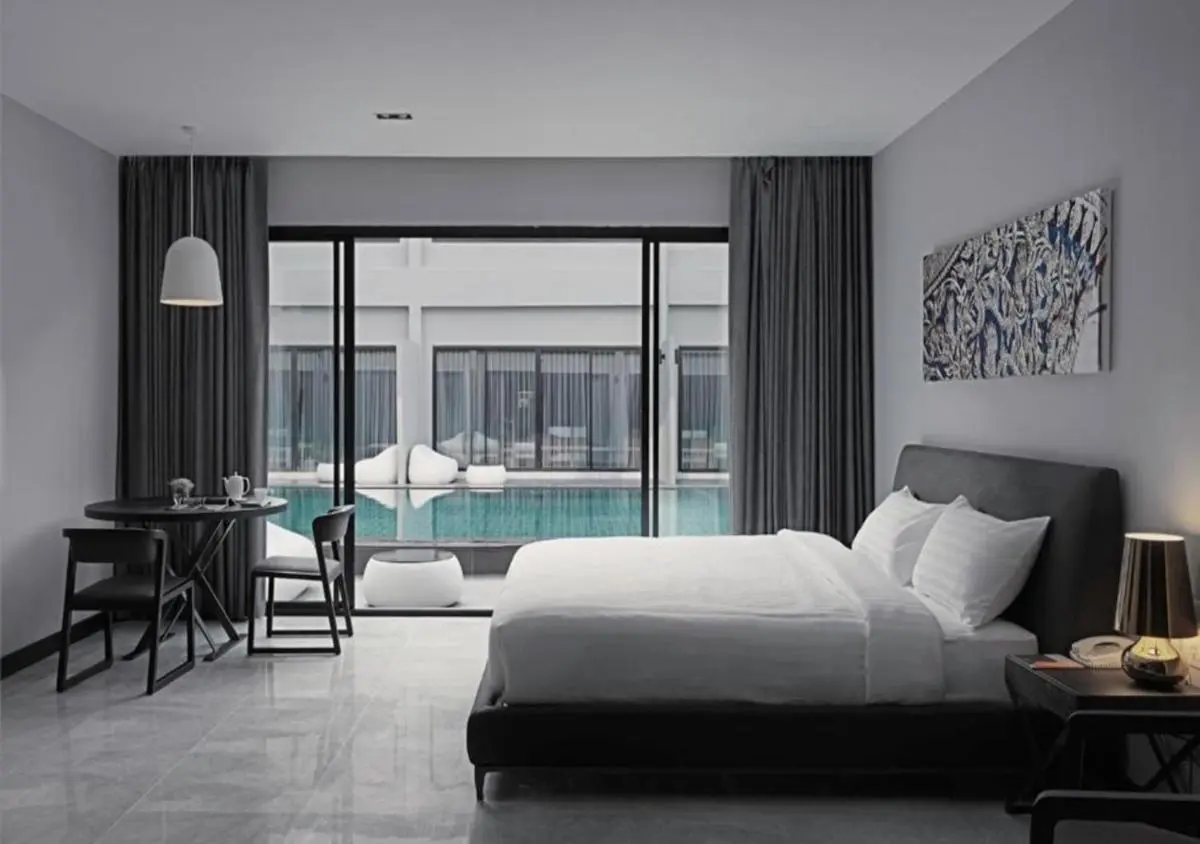 S Ratchada Leisure Hotel Modern Minimalist Bedroom with Pool View and Outdoor Seating in Huai Khwang Bangkok