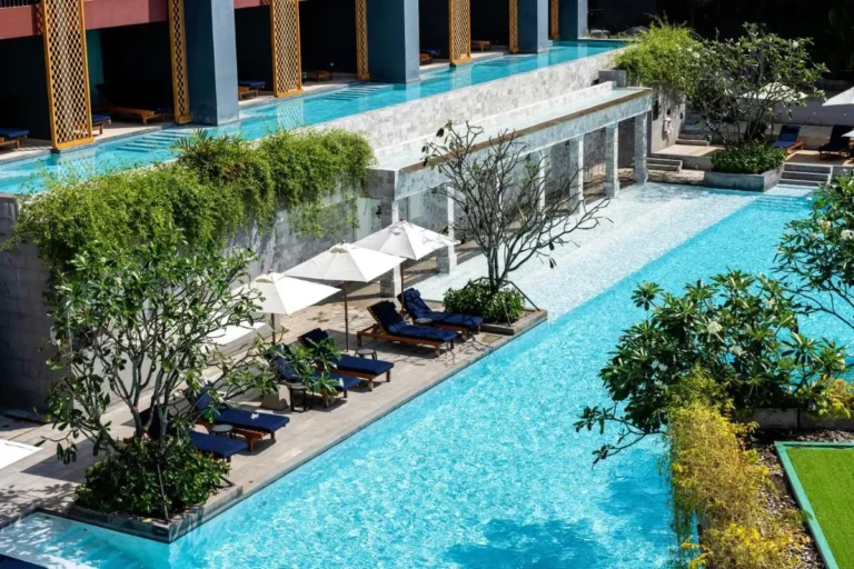 Modern Multi-Level Outdoor Pool Area with Loungers and Greenery at Karon Beach