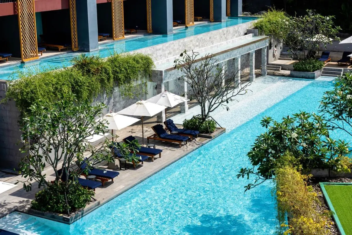Modern Multi-Level Outdoor Pool Area with Loungers and Greenery at Karon Beach