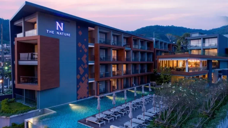 Modern Multi-Story Building with Rectangular Pool and Outdoor Lounging Area at Patong Beach