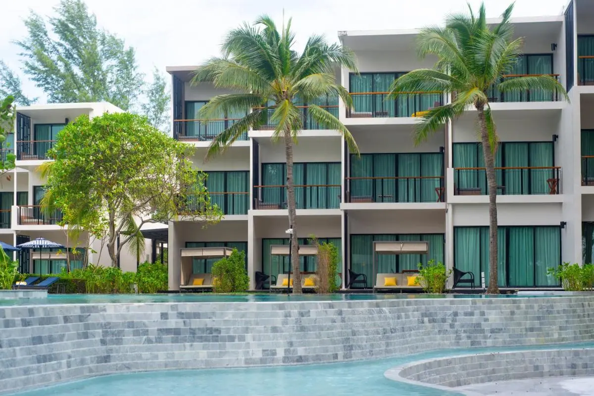 Modern Multi-Story Building with Tiered Swimming Pool and Outdoor Lounge Areas at Mai Khao Beach