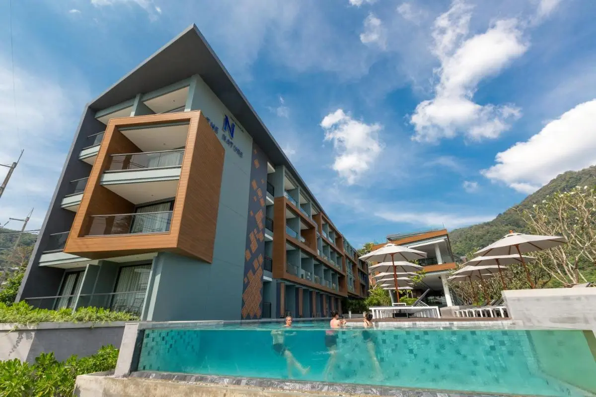 Modern Multi-Story Building with Transparent Swimming Pool and Poolside Seating at Patong Beach