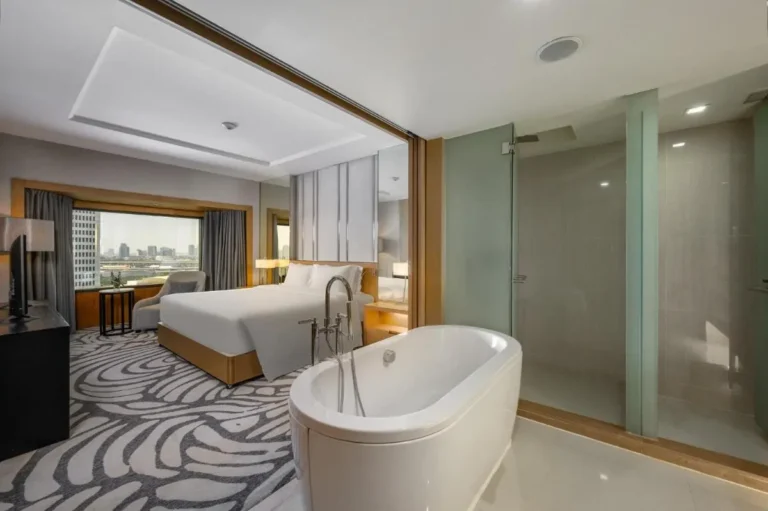 Modern Open-Plan Hotel Room with Freestanding Bathtub and Urban View in Chatuchak