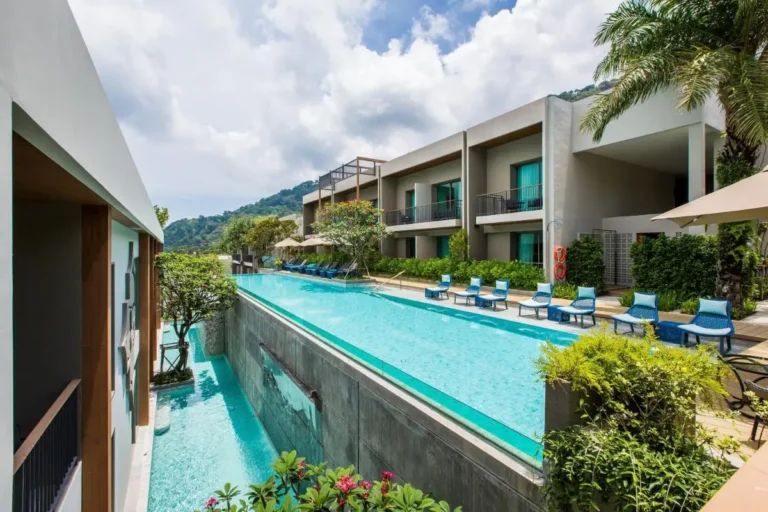 Modern Outdoor Elevated Pool Area with Lounge Seating and Glass Barriers at Patong Beach