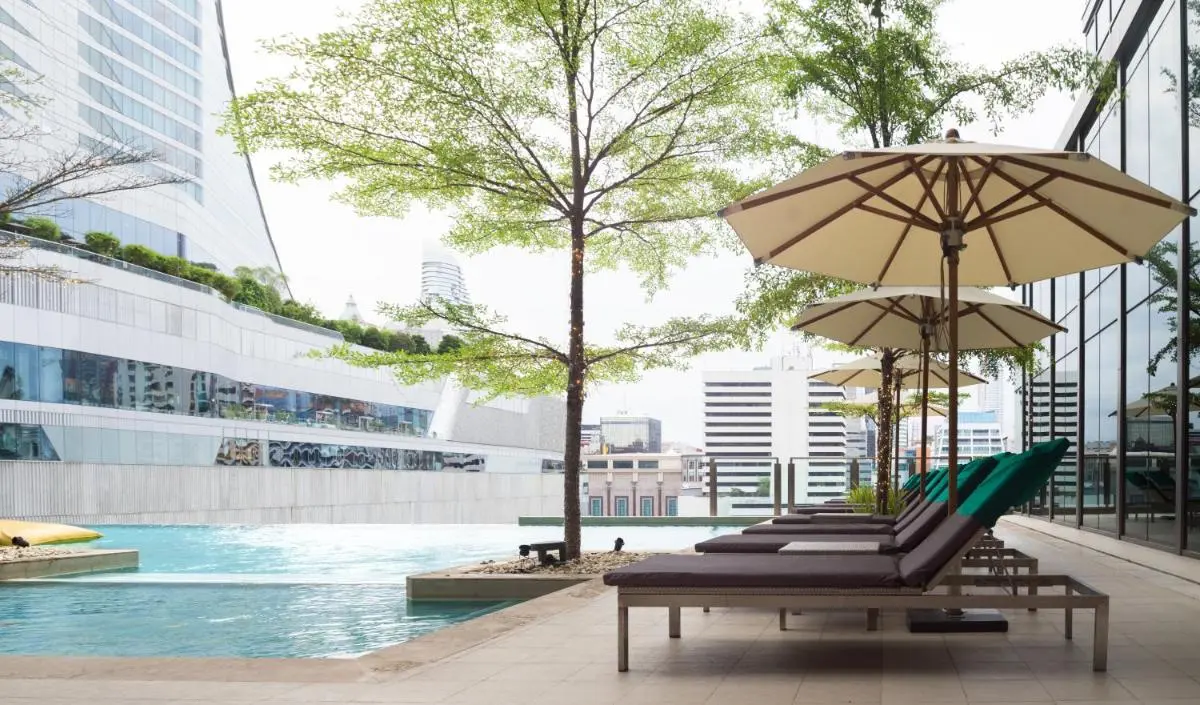 Sivatel Bangkok Hotel Modern Outdoor Infinity Pool and Relaxation Area with Lounge Chairs in Pathumwan Bangkok Bangkok Province
