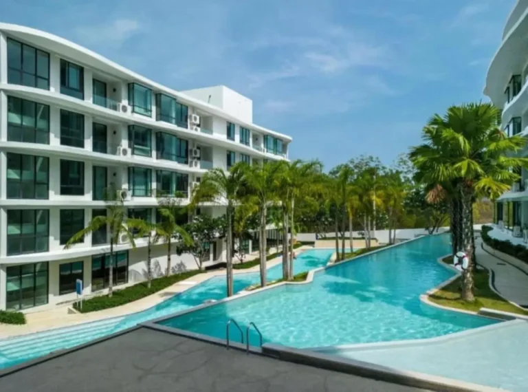 Modern Outdoor Pool Area Between Multi-Story Buildings with Tropical Landscaping at Rawai Beach