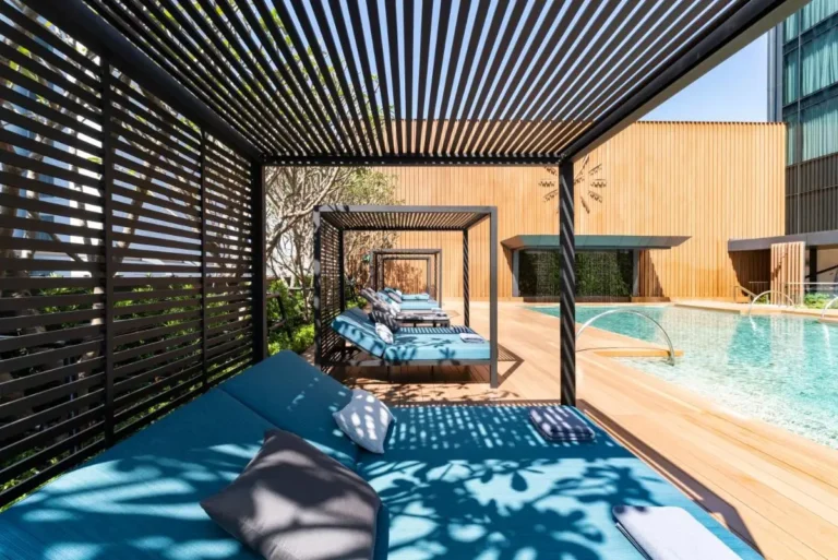 Modern Outdoor Pool Area with Cabanas and Water Jets in Wattana Bangkok