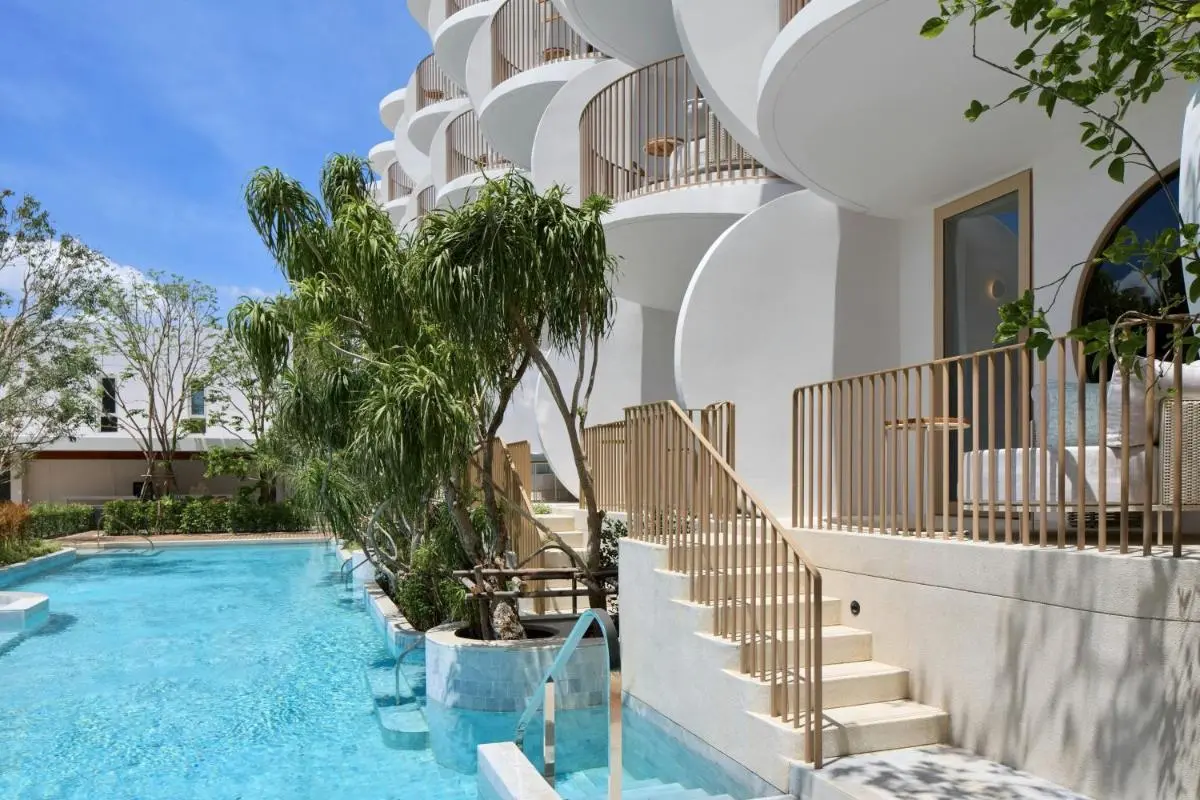 Modern Outdoor Pool Area with Curved Balconies and Natural Greenery at Panwa Beach