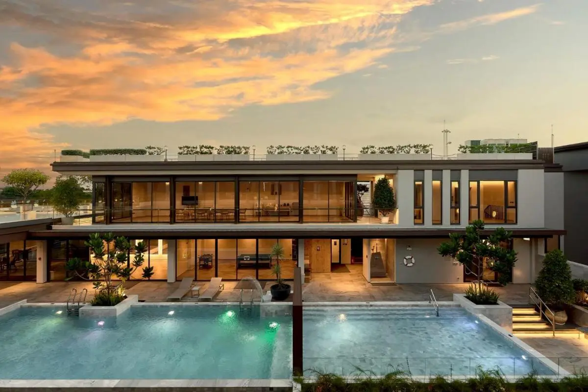 Modern Outdoor Pool Area with Dual Pools and Lounge Seating in Chang Phueak Chiang Mai
