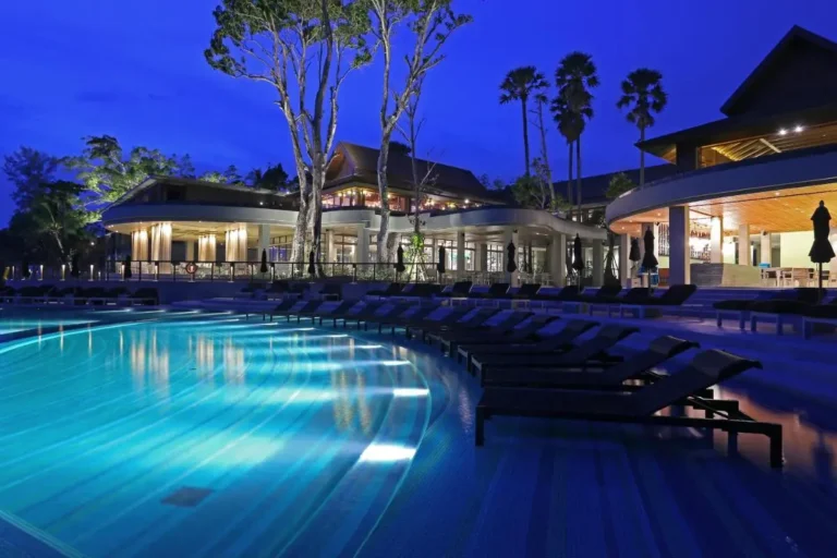 Modern Outdoor Pool Area with Lounge Chairs and Bar at Nai Thon Beach