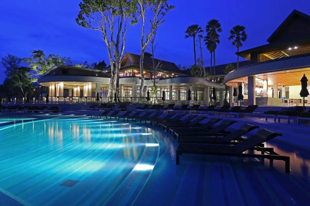 Modern Outdoor Pool Area with Lounge Chairs and Bar at Nai Thon Beach