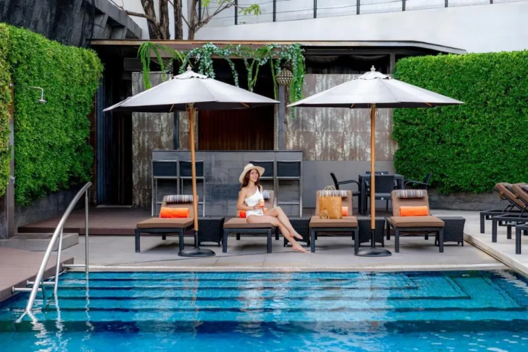 Modern Outdoor Pool Area with Lounge Chairs and Bar in Wattana Bangkok