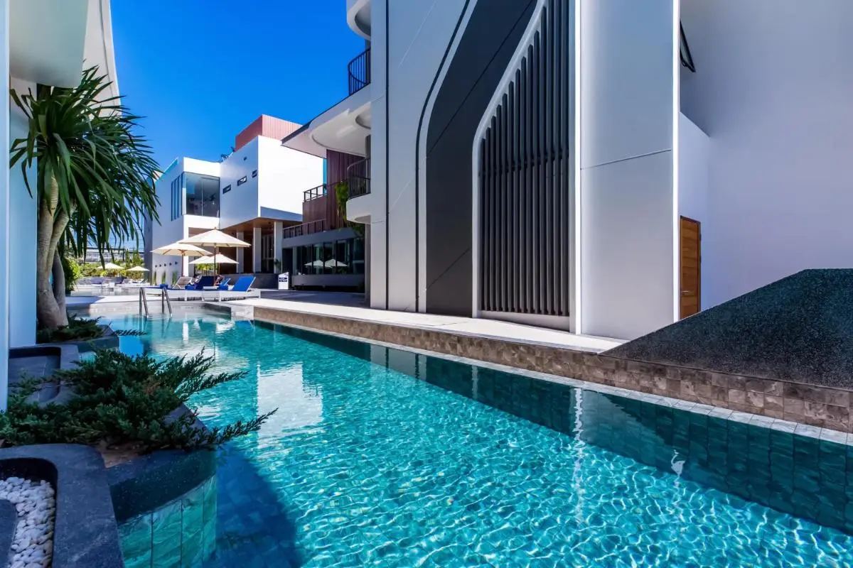 Wintree City Resort Chiang Mai Modern Outdoor Pool Area with Lounge Chairs and Minimalist Architecture in Chiang Mai