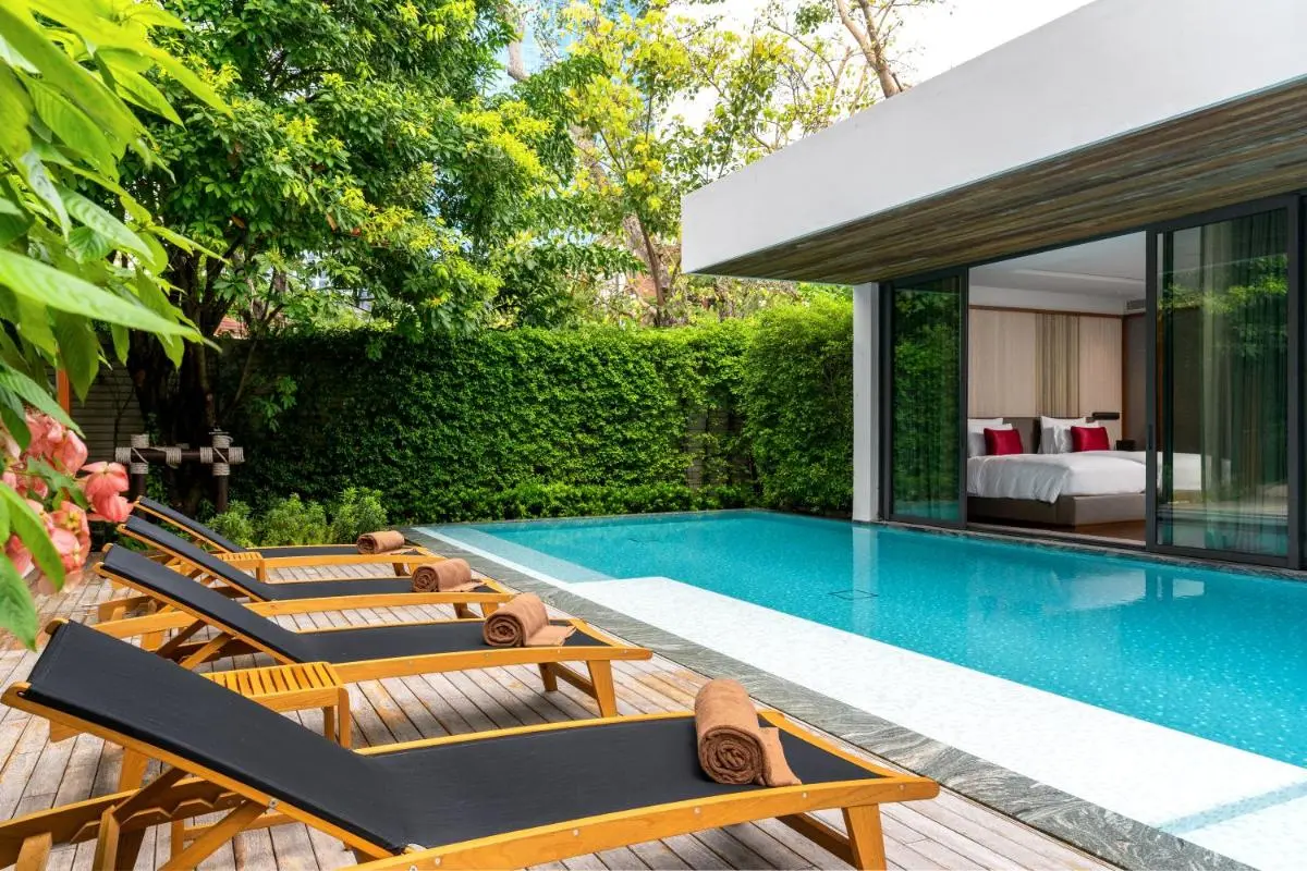 Modern Outdoor Pool Area with Lounge Chairs and Private Garden in Sathorn Bangkok