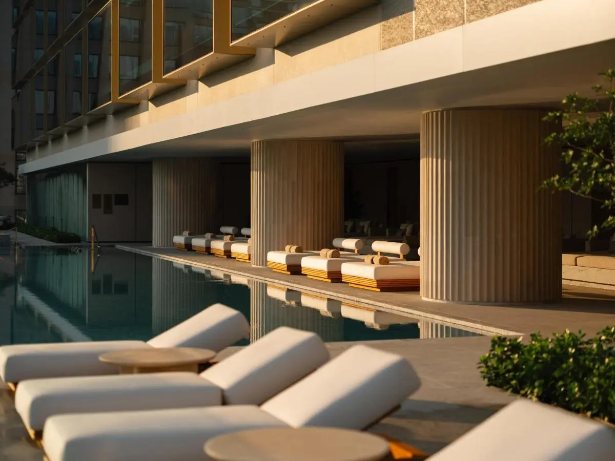 Dusit Thani Bangkok Modern Outdoor Pool Area with Lounge Chairs and Shaded Deck in Bang Rak
