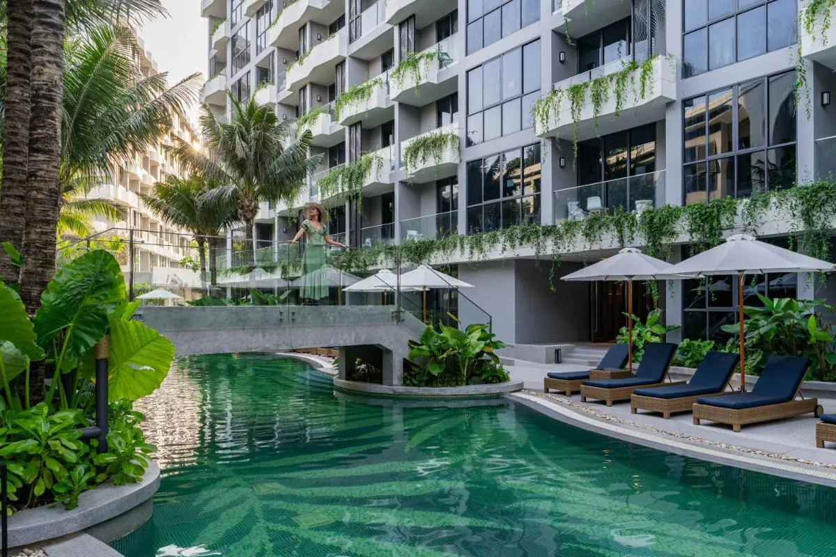 Modern Outdoor Pool Area with Lounge Chairs and Tropical Landscaping at Bang Tao Beach