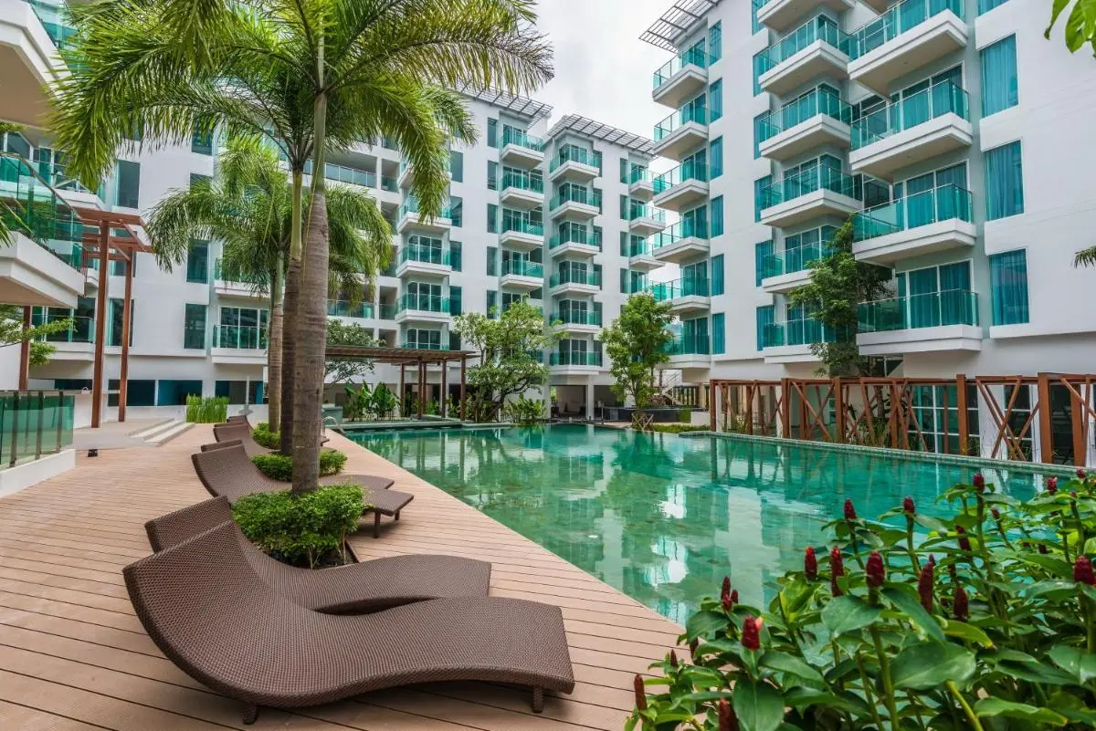 Fishermens Harbour Urban Resort - SHA Extra Plus Modern Outdoor Pool Area with Lounge Chairs and Tropical Landscaping at Patong Beach