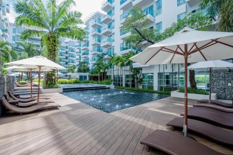 Modern Outdoor Pool Area with Lounge Chairs and Tropical Landscaping at Patong Beach