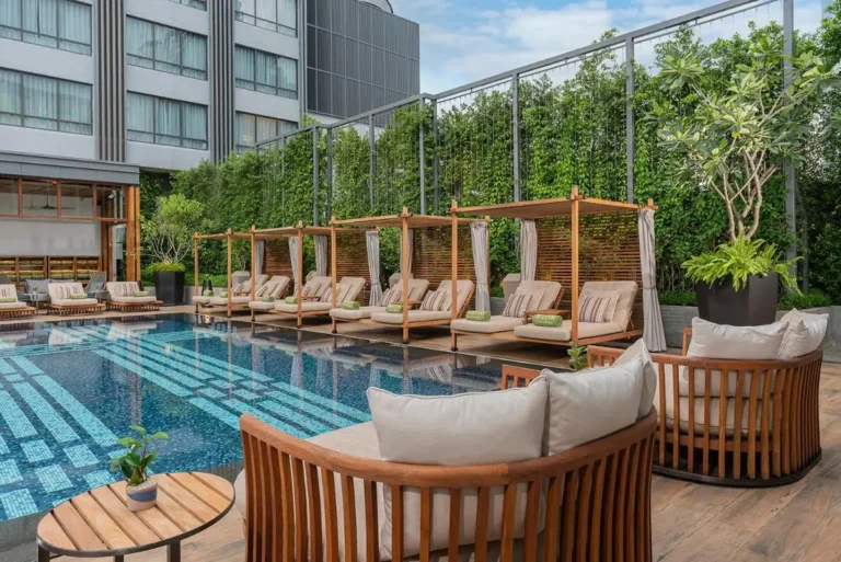 Modern Outdoor Pool Area with Lounge Seating and Green Wall in Chang Khlan Chiang Mai