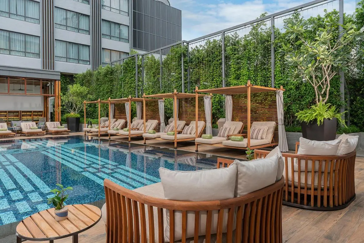 Modern Outdoor Pool Area with Lounge Seating and Green Wall in Chang Khlan Chiang Mai