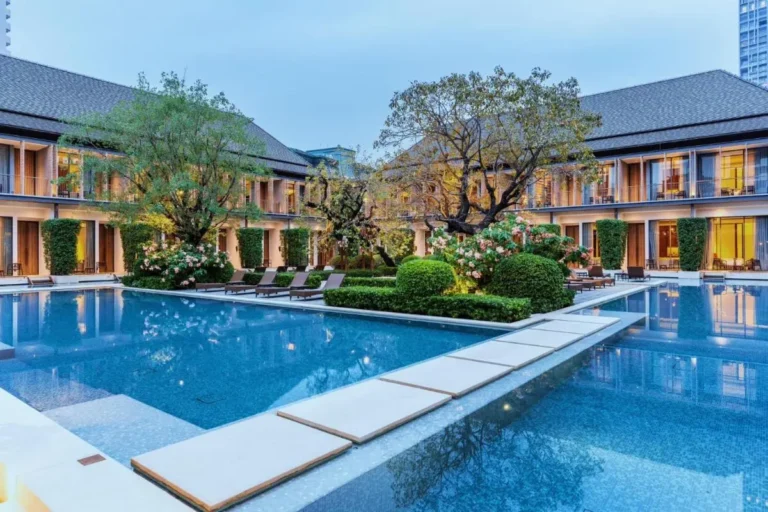 Modern Outdoor Pool Area with Lounge Seating and Landscaping in Sathorn Bangkok