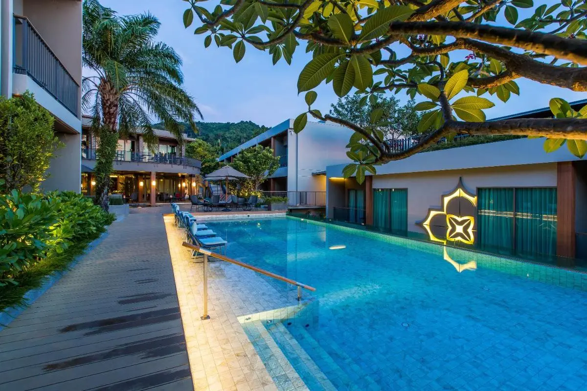 Modern Outdoor Pool Area with Lounge Seating and Tropical Landscaping at Patong Beach