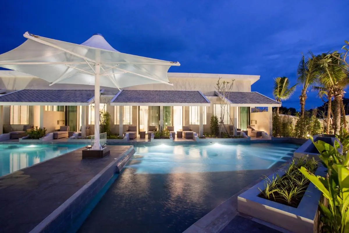 Modern Outdoor Pool Area with Lounge Seating and Tropical Landscaping in Phuket Town