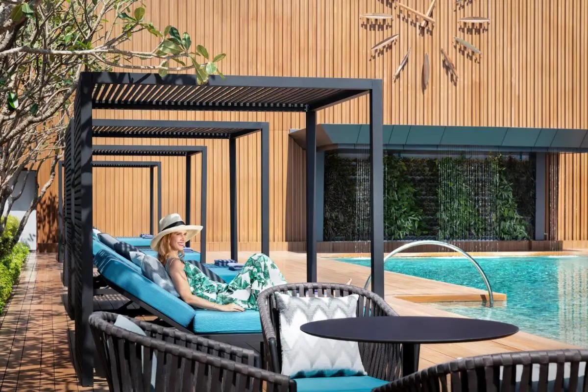 Modern Outdoor Pool Area with Pergolas and Lounge Seating in Wattana Bangkok